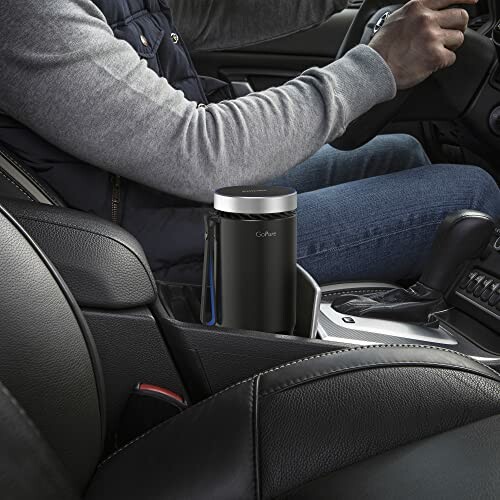 Car trash can in center console with person driving.